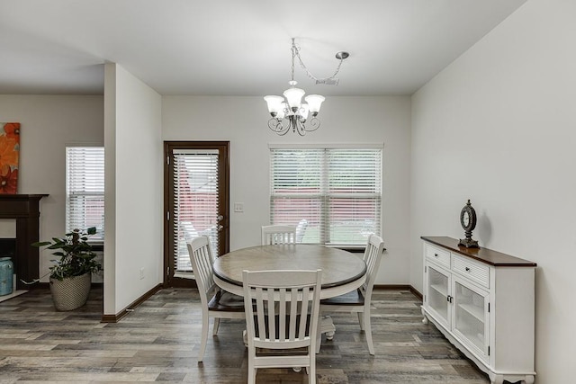 893 Whitfield Oak Rd, Auburn, GA 30011 - dining area with a chandelier, wood finished floors, and baseboards