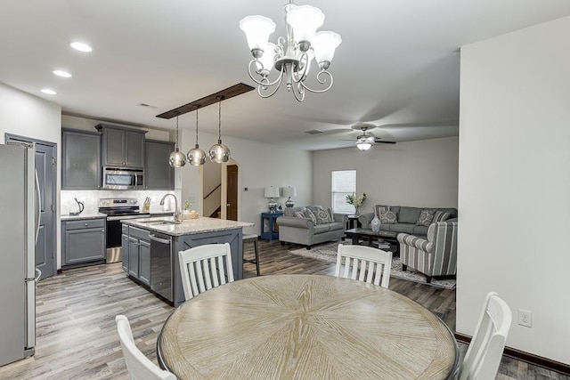 893 Whitfield Oak Rd, Auburn, GA 30011 - dining area featuring ceiling fan, light wood-type flooring, a chandelier, recessed lighting, and arched walkways
