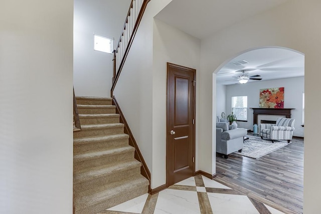 893 Whitfield Oak Rd, Auburn, GA 30011 - stairway with a ceiling fan, arched walkways, and baseboards