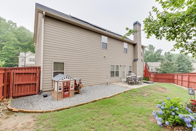 893 Whitfield Oak Rd, Auburn, GA 30011 - back of house with a chimney and a patio