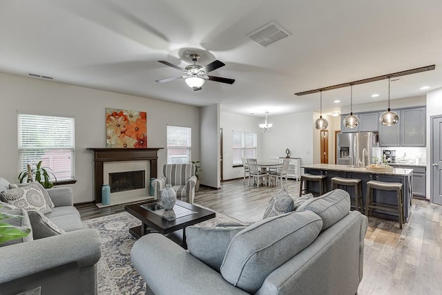 893 Whitfield Oak Rd, Auburn, GA 30011 - living room with healthy amount of natural light, a ceiling fan, a fireplace, light wood finished floors, and recessed lighting