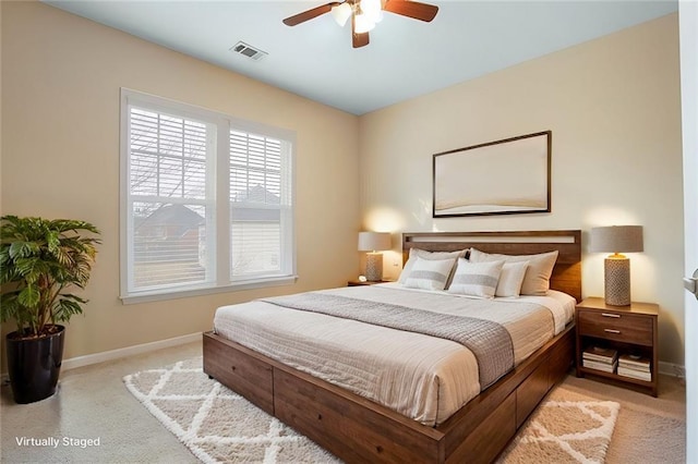 bedroom with visible vents, a ceiling fan, baseboards, and light carpet