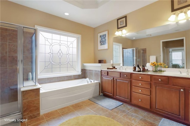 full bath featuring a shower stall, tile patterned floors, double vanity, a sink, and a bath
