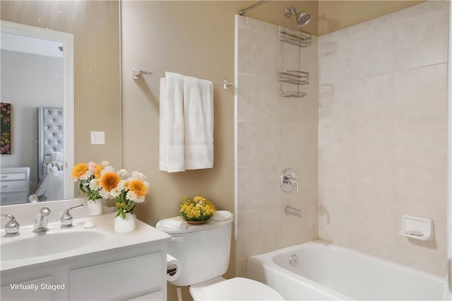 full bathroom with washtub / shower combination, vanity, and toilet