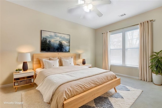 bedroom with light carpet, baseboards, visible vents, and a ceiling fan