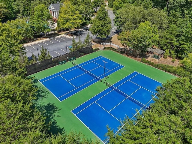 view of tennis court featuring fence