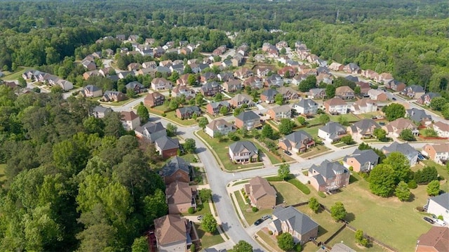 birds eye view of property featuring a residential view and a wooded view