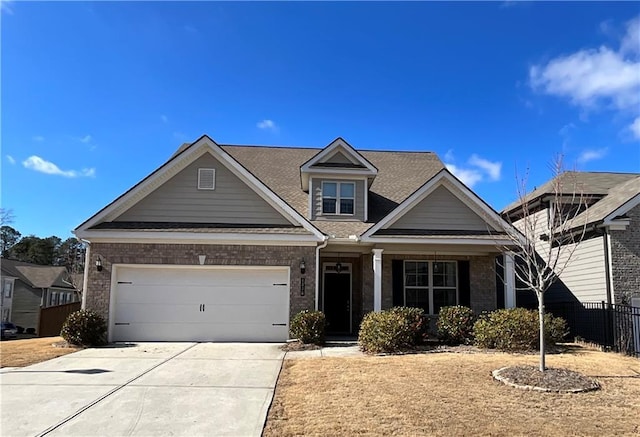 view of front of property featuring concrete driveway, brick siding, an attached garage, and fence