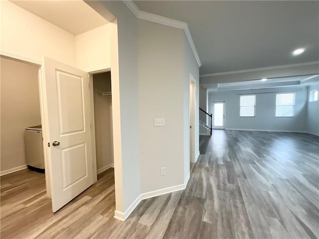 interior space featuring ornamental molding, stairway, wood finished floors, and baseboards