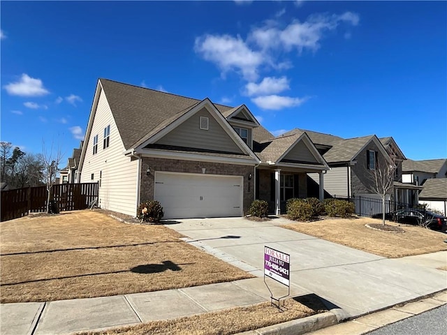 view of front of home with an attached garage, fence, concrete driveway, and brick siding