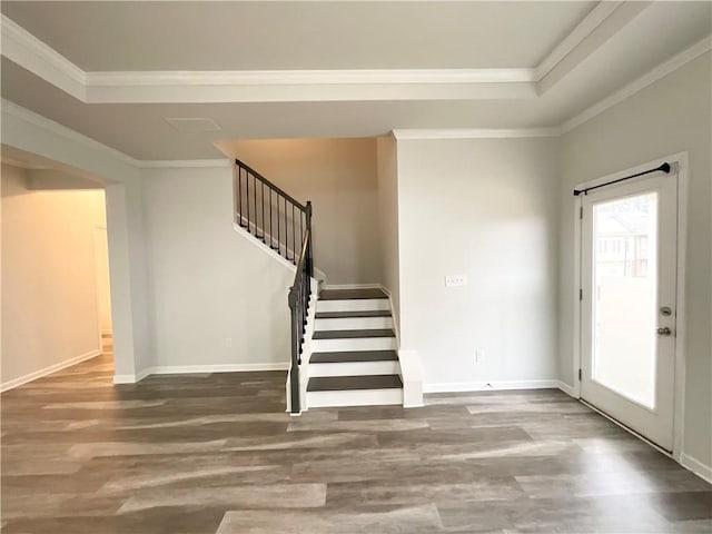 interior space with ornamental molding, stairway, wood finished floors, and baseboards