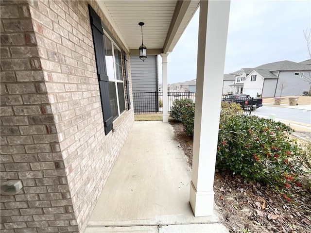 view of patio / terrace featuring a porch and a residential view