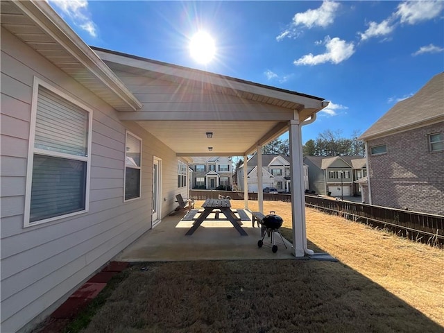 view of patio / terrace with a residential view and fence