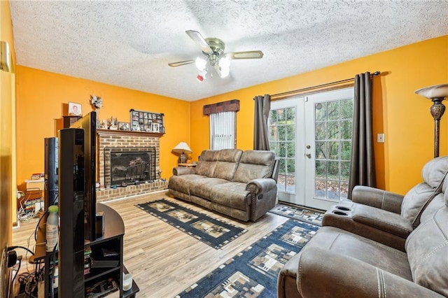 living room featuring french doors, a textured ceiling, and hardwood / wood-style flooring