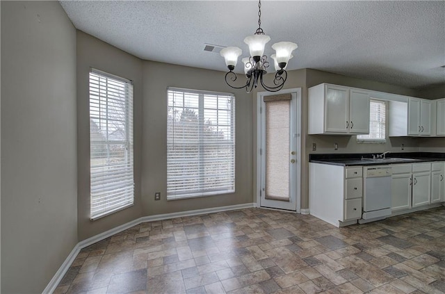 kitchen with white dishwasher, a notable chandelier, white cabinetry, and pendant lighting