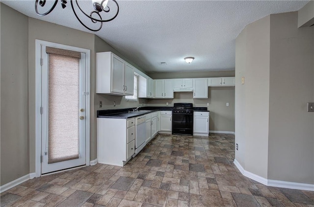 kitchen with white cabinetry, white dishwasher, gas range oven, and a textured ceiling