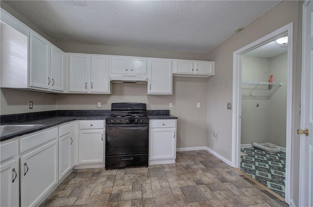 kitchen with black gas range, sink, a textured ceiling, and white cabinets