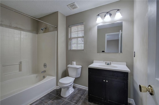 full bathroom with tile patterned flooring, vanity,  shower combination, toilet, and a textured ceiling