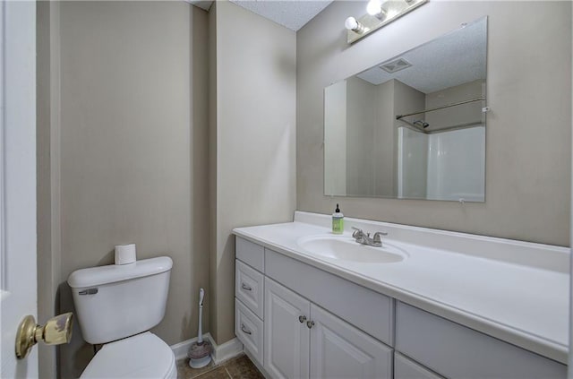 bathroom with walk in shower, vanity, toilet, and tile patterned flooring