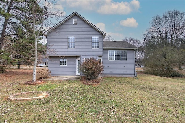 rear view of house featuring a yard and a patio area