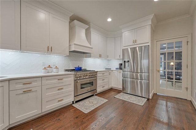 kitchen with premium range hood, light countertops, appliances with stainless steel finishes, white cabinetry, and tasteful backsplash