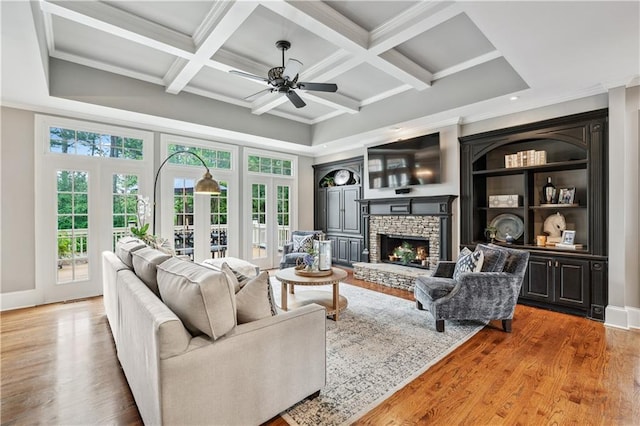7025 Windsor Hill Psge, Suwanee, GA 30024 - living area with a fireplace, coffered ceiling, wood finished floors, ornamental molding, and ceiling fan