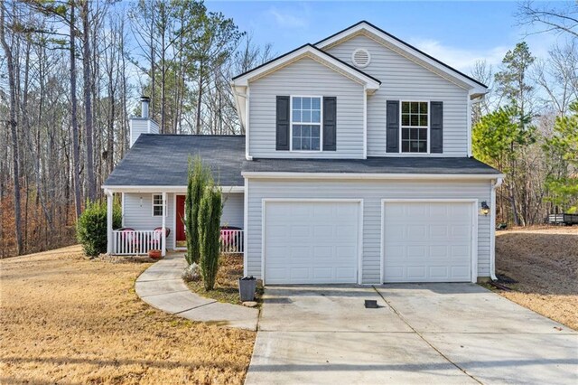 view of property with a porch and a garage