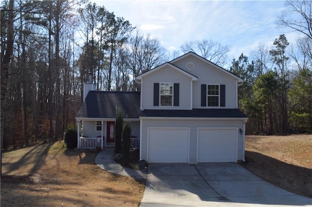 view of property with a garage and covered porch