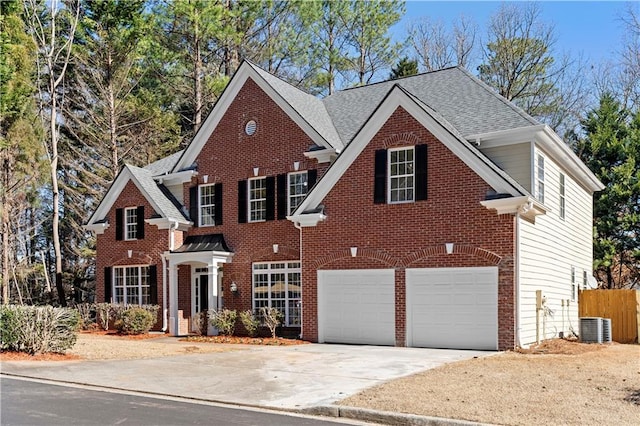 view of property with central AC unit and a garage