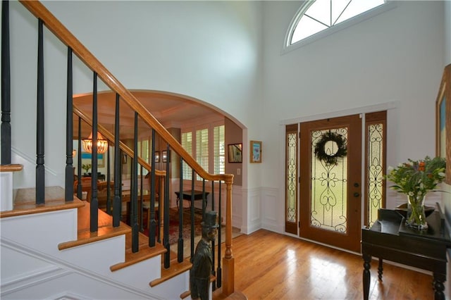 2637 Morningside Trl NW, Kennesaw, GA 30144 - foyer featuring arched walkways, plenty of natural light, wood finished floors, stairway, and a high ceiling