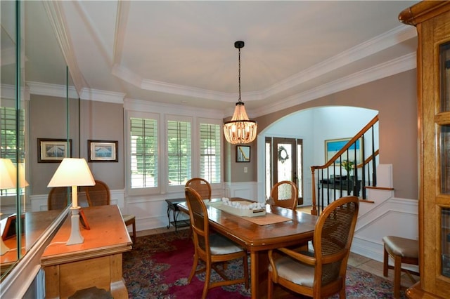 2637 Morningside Trl NW, Kennesaw, GA 30144 - dining space featuring a chandelier, a decorative wall, wainscoting, crown molding, and stairway