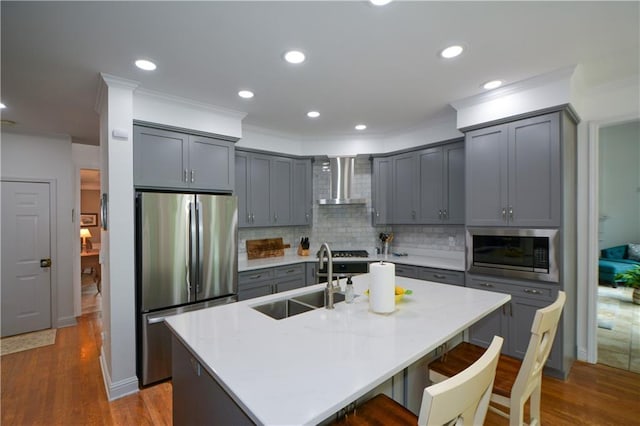 2637 Morningside Trl NW, Kennesaw, GA 30144 - kitchen with stainless steel appliances, wall chimney range hood, a sink, gray cabinetry, and ornamental molding