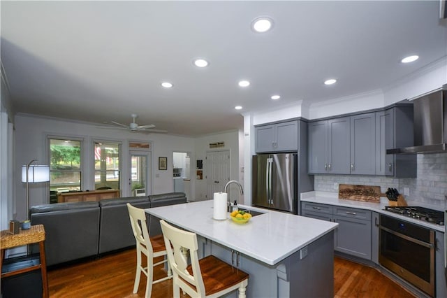 2637 Morningside Trl NW, Kennesaw, GA 30144 - kitchen featuring stainless steel appliances, a sink, wall chimney exhaust hood, gray cabinets, and crown molding