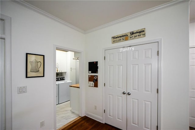 2637 Morningside Trl NW, Kennesaw, GA 30144 - hall with washer / dryer, crown molding, dark wood-style flooring, and baseboards