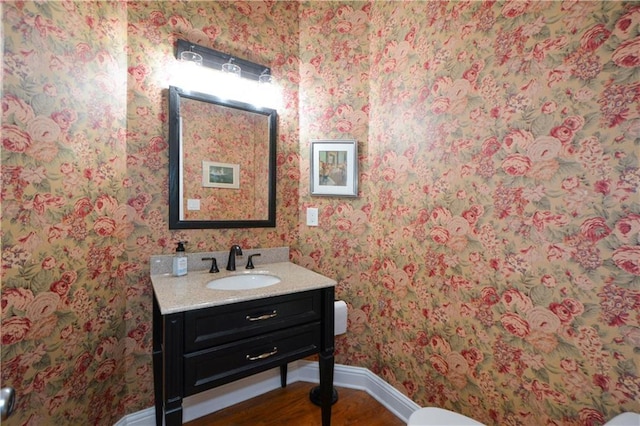 2637 Morningside Trl NW, Kennesaw, GA 30144 - bathroom with baseboards, wallpapered walls, vanity, wood finished floors, and toilet