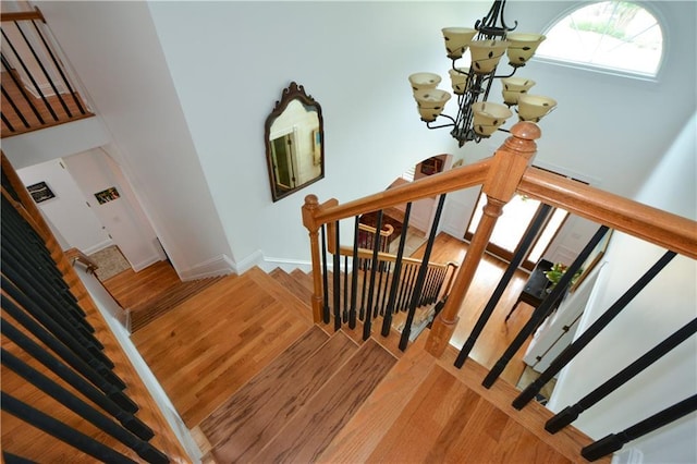 2637 Morningside Trl NW, Kennesaw, GA 30144 - stairway with a chandelier, wood finished floors, and baseboards