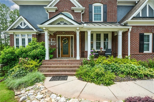 2637 Morningside Trl NW, Kennesaw, GA 30144 - view of exterior entry with brick siding, covered porch, and a standing seam roof