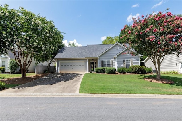 ranch-style home featuring a garage and a front yard