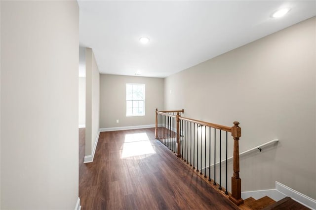 hallway with dark hardwood / wood-style flooring