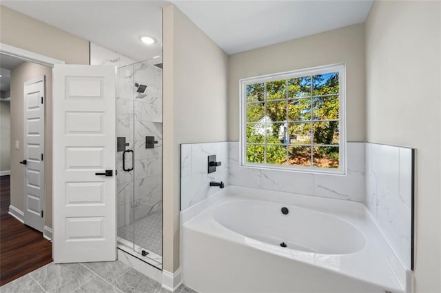 bathroom featuring independent shower and bath and hardwood / wood-style flooring