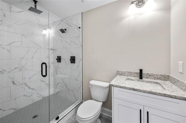 bathroom featuring vanity, toilet, and a shower with shower door