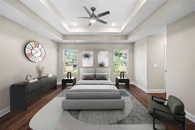 bedroom with dark wood-type flooring, multiple windows, and ceiling fan