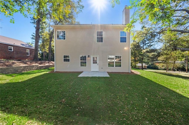 rear view of house with a patio area and a lawn