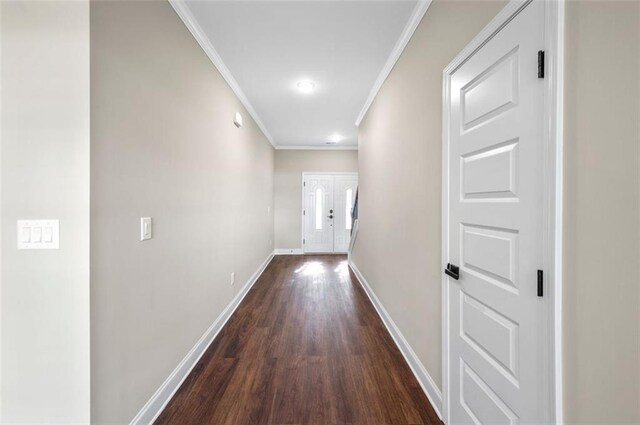 hallway featuring crown molding and dark hardwood / wood-style flooring