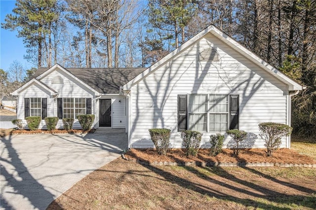 ranch-style home with concrete driveway