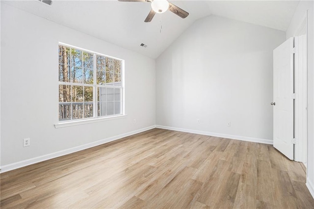 interior space featuring lofted ceiling, a ceiling fan, baseboards, visible vents, and light wood-style floors