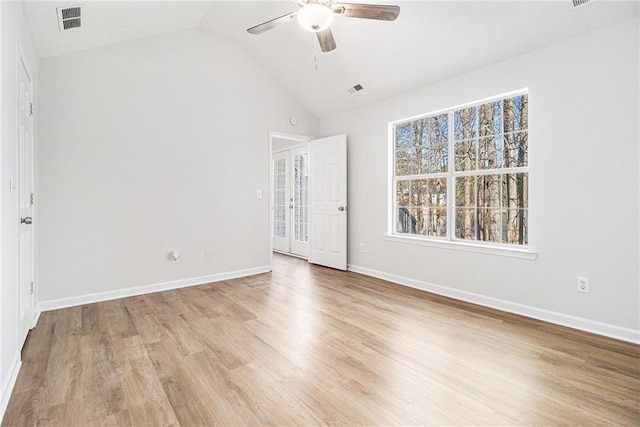 unfurnished bedroom featuring light wood-style flooring, a ceiling fan, visible vents, vaulted ceiling, and baseboards