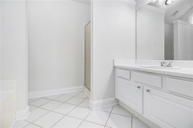 bathroom with visible vents, a shower stall, vanity, tile patterned flooring, and baseboards