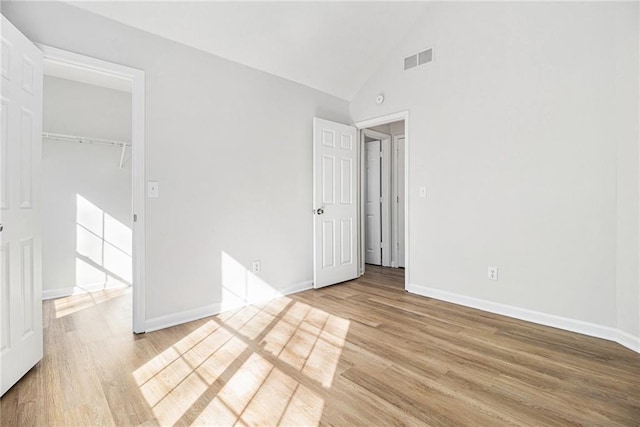 unfurnished bedroom with visible vents, baseboards, and wood finished floors