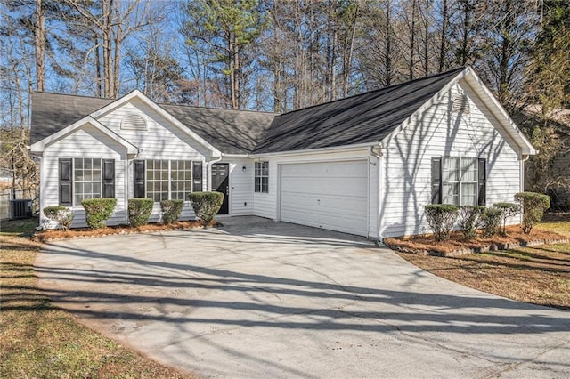 ranch-style house with an attached garage, driveway, and central AC unit